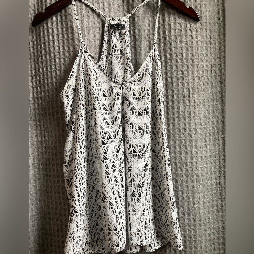 Beautiful black and white summer top. Adjustable straps. Like new condition.